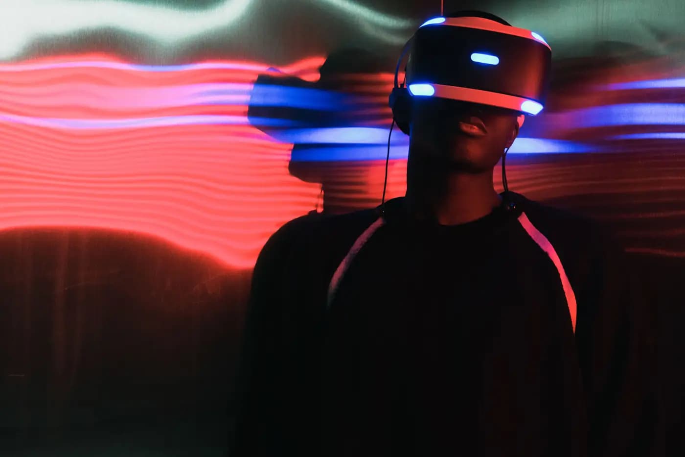 A person using a headset against a field of colour and light